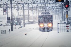 雪の中を進む普通列車（Webライターの経費関連）